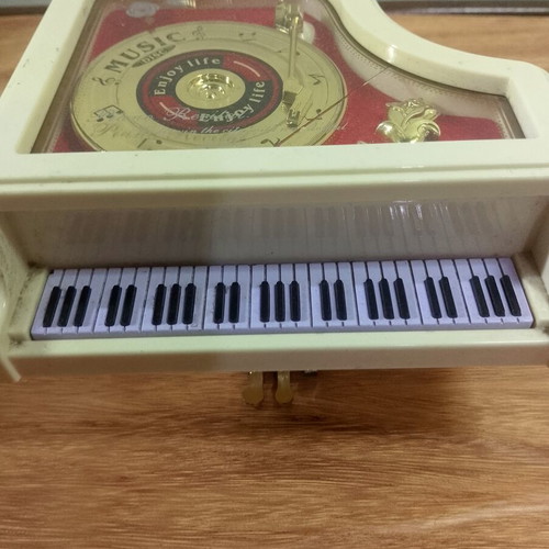 White piano music box with golden record and rose design