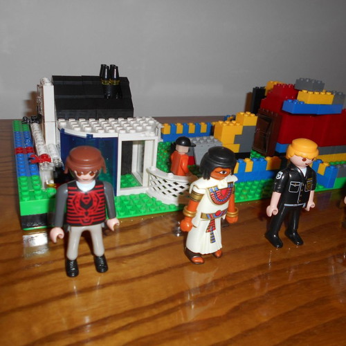 Building toy with Lego bricks and 6 Play Mobil figures used
