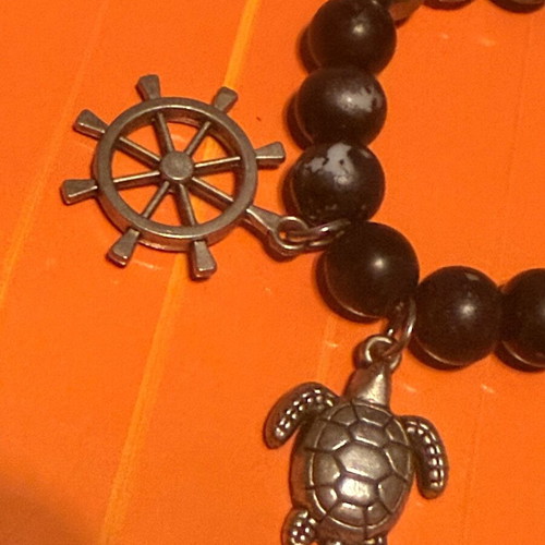 Elastic bracelet like new with steering wheel and turtle charms black-silver