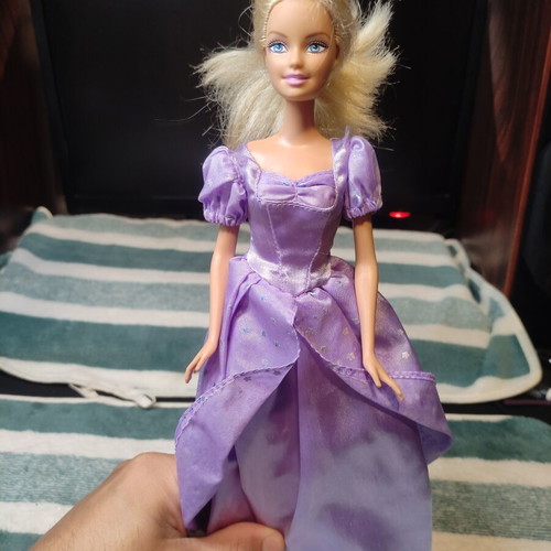 Barbie with lilac dress used, torn shoulders