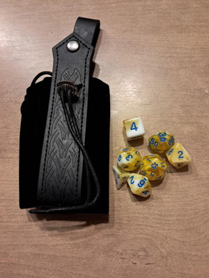Black leather runic dice bag with yellow marbled D&D dice