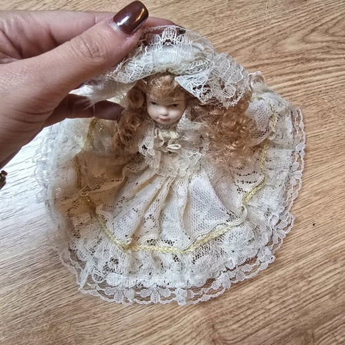 Glass bride doll like new with hat and lace