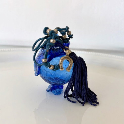 Handmade glass lucky charm in blue shades with horseshoe and silk tassel