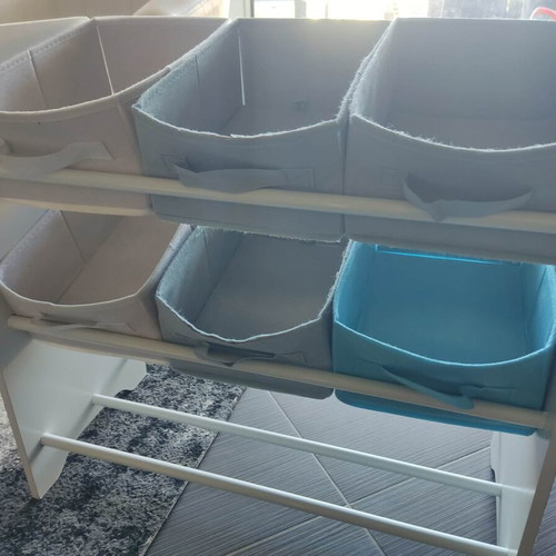 Children's storage shelf used with fabric bins and planet motifs