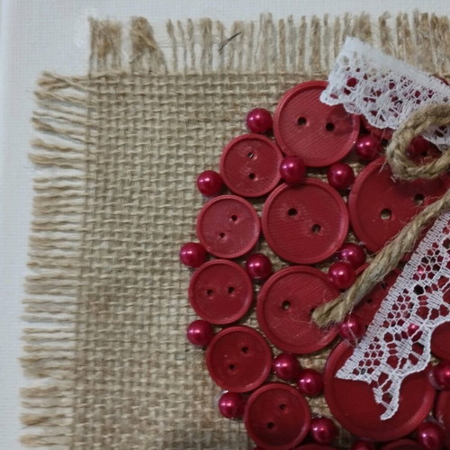 Handmade frame new with heart of buttons on canvas