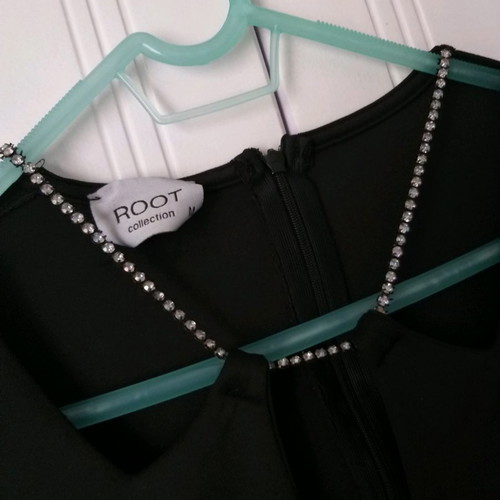 Black dress size M with open neckline, unused
