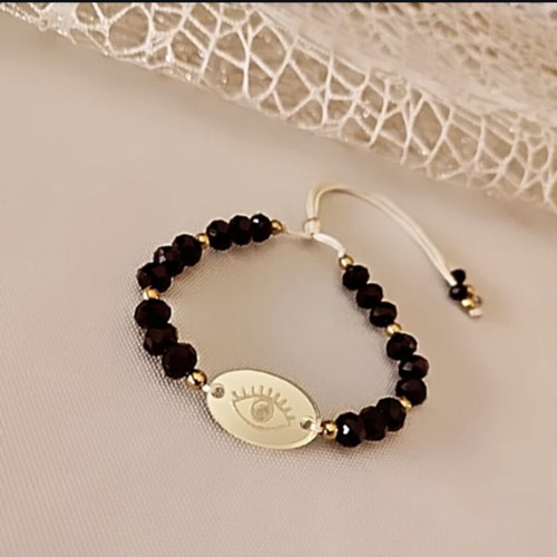 Bracelet with black crystals and acrylic eye like new, adjustable cord