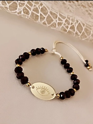 Bracelet with black crystals and acrylic eye like new, adjustable cord