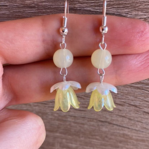 Handmade earrings with yellow and white beads and silver metal details