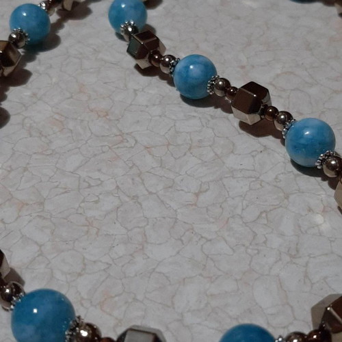 Necklace with dark blue larimar and gold hematite on steel