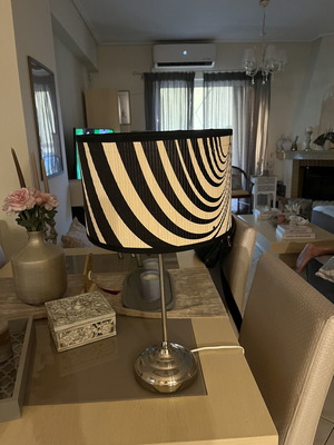 Modern table lamp with black and white geometric shade, optical art