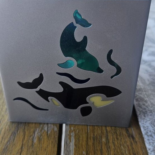 Metal tealight holder with stained glass dolphins