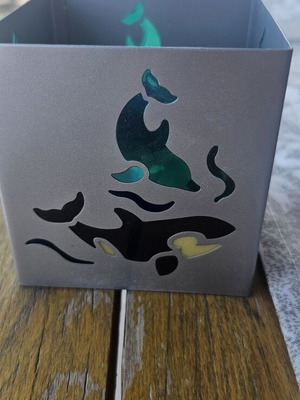 Metal tealight holder with stained glass dolphins