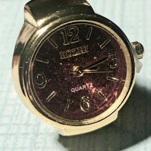 Quartz ring watch like new with purple dial and gold bracelet