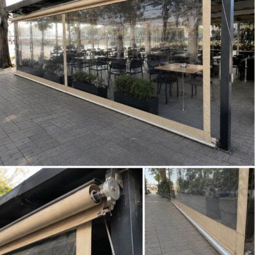 Vertical transparent PVC awnings used with mechanism for cafes and restaurants