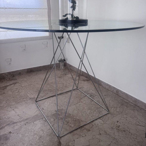 Round glass dining table used with silver detailing 100x76