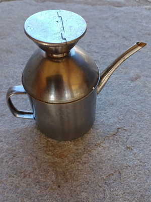 Small stainless steel oil dispenser used