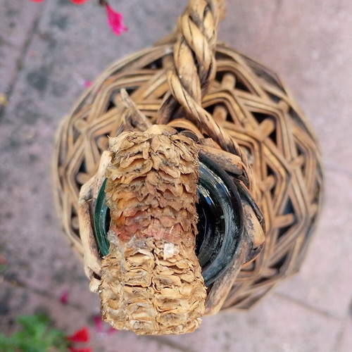 Vintage wicker wrapped demijohn with corncob stopper, used
