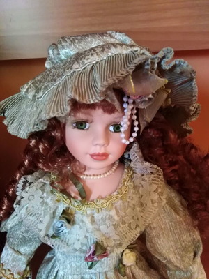 Porcelain decorative doll new with red hair and green eyes