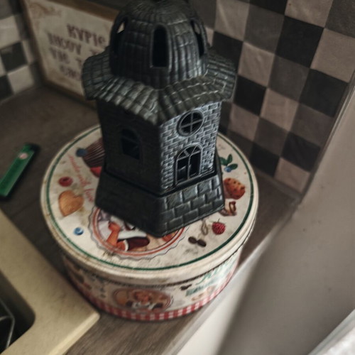 Candle holder used, church-shaped without glass cup, black
