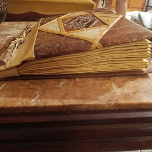 Handmade photo album with carved wooden details, vintage style
