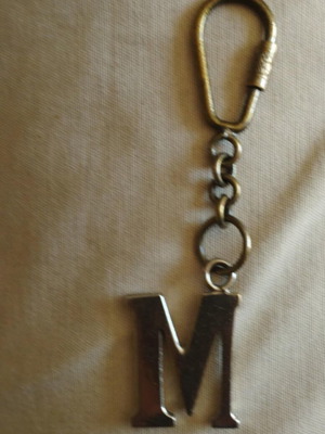 Bronze keychain key holder with monogram M on chain used