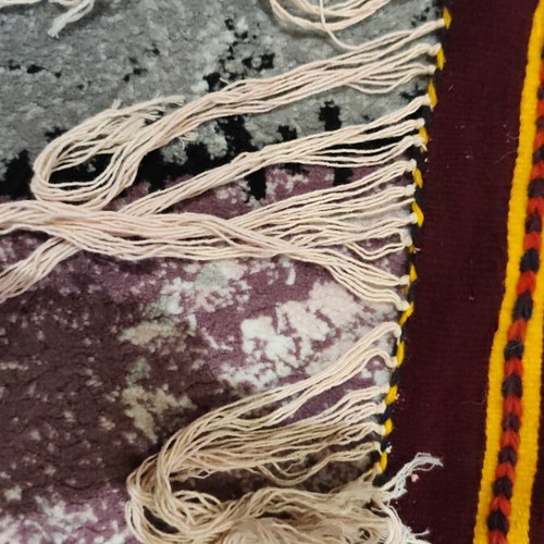 Woven rug used with geometric motifs and fringes