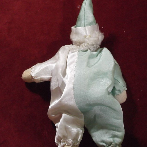 Porcelain clown doll used with white and green satin costume