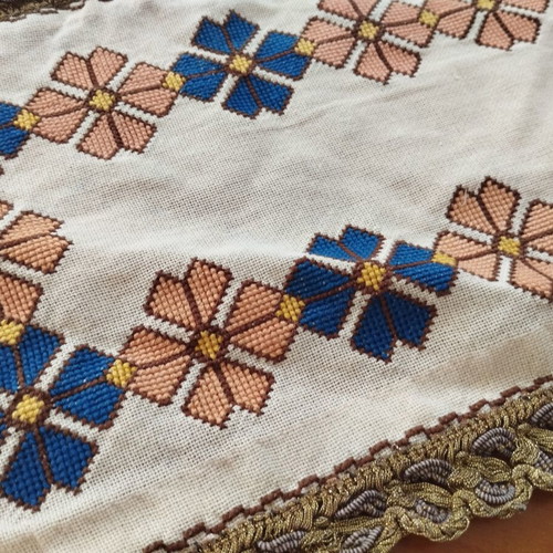 Vintage handmade embroidered table linens with cross-stitch and gold thread