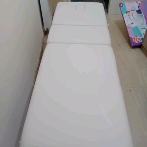 Massage bed like new, white with nickel base and folding feature