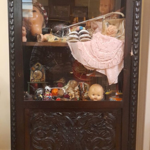 Vintage wooden display cabinet with carved details and glass front used