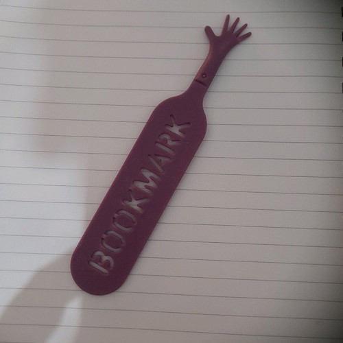 Plastic bookmark used, hand shape