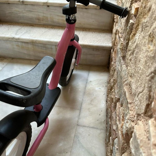 Balance bike pink like new with minor scratches on handlebar