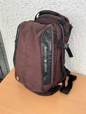 Magic Marine Backpack used with rain cover, black and brown