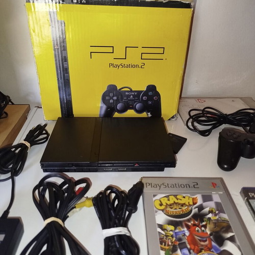 PlayStation 2 console with original controller, memory card and 2 games