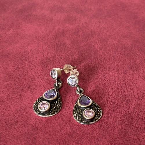 Silver earrings used with purple stones
