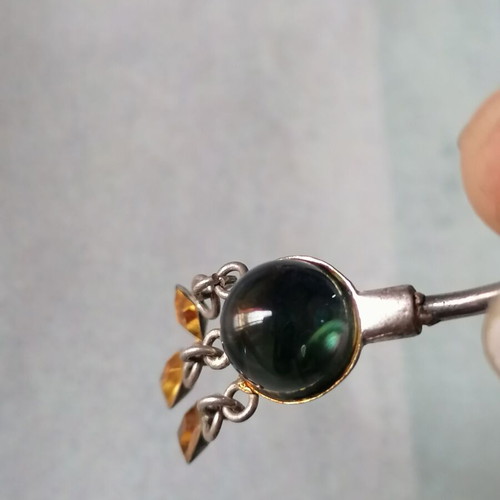 Aurora borealis navel piercing with color-changing crystal