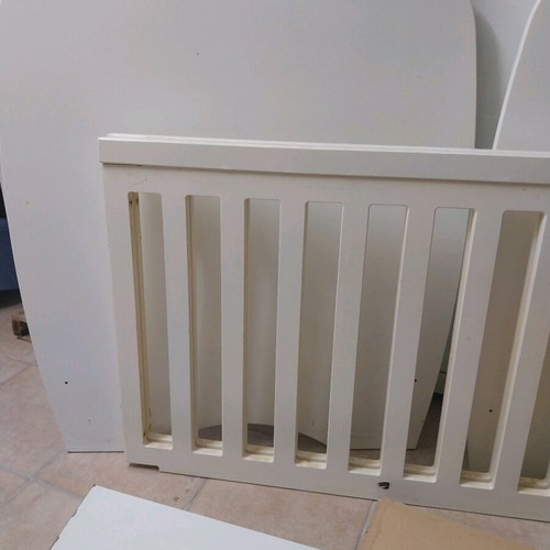 Baby cot used with accessories and fresh sheets