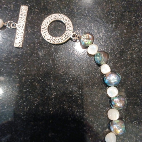 Necklace with white and olive stones, carved clasp, like new