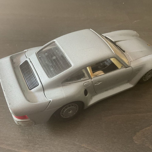 Burago metal toy car Porsche 959 M1:24 used with missing headlight and cracked glass