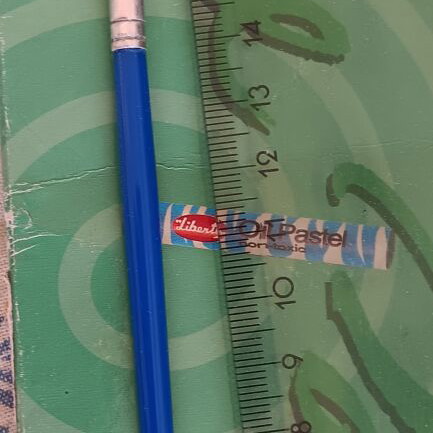 School round paintbrush with blue handle and synthetic bristles