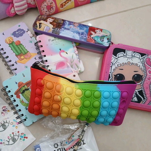 School supplies used, pencil cases, erasers, paints, notebooks, pencils