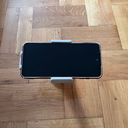 White mobile phone holder used with strong suction cup for car