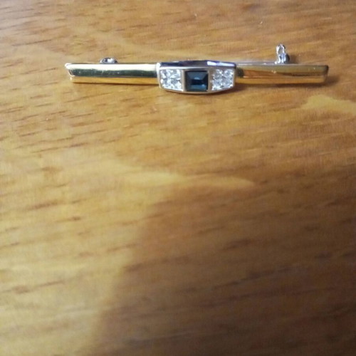 Jewelry pin like new, gold color with blue and clear stones