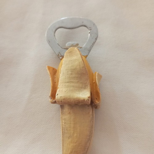 Banana-shaped bottle opener magnet