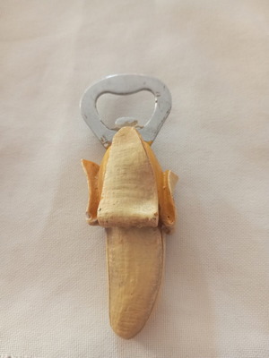 Banana-shaped bottle opener magnet