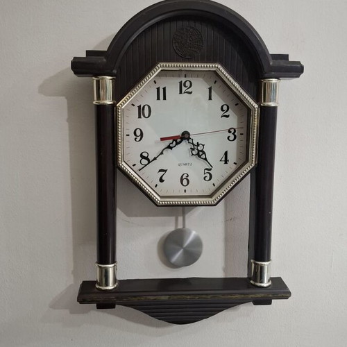 Quartz wall clock with pendulum used, faux wood plastic