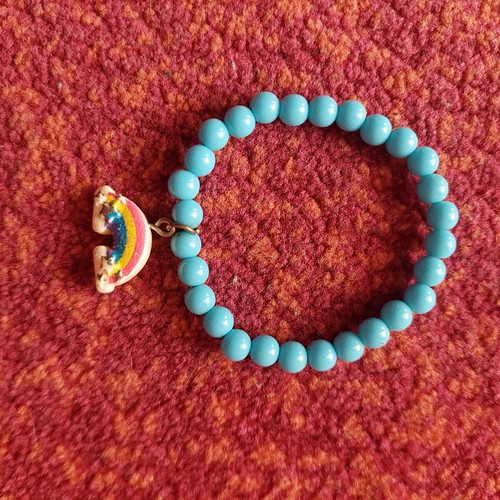 Children's turquoise bracelet with rainbow charm like new