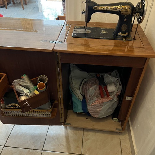 Singer sewing machine used with decorative cabinet