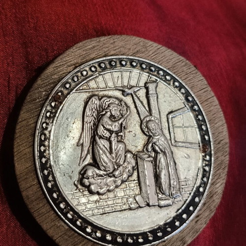 Old metal religious icon on wooden board, used